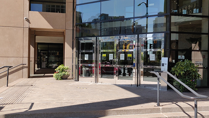 New health and safety signs are displayed on the public doors and lobby entrance, to Library square tower in our Vancouver location.