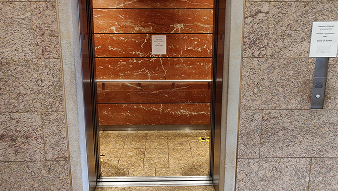 In the lobby elevator, there are physical distancing signs or markings along with the 2-people limit inside the elevators, as part of the new health and safety measures in place.